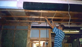 Dave drilling ventilation holes in the beams.